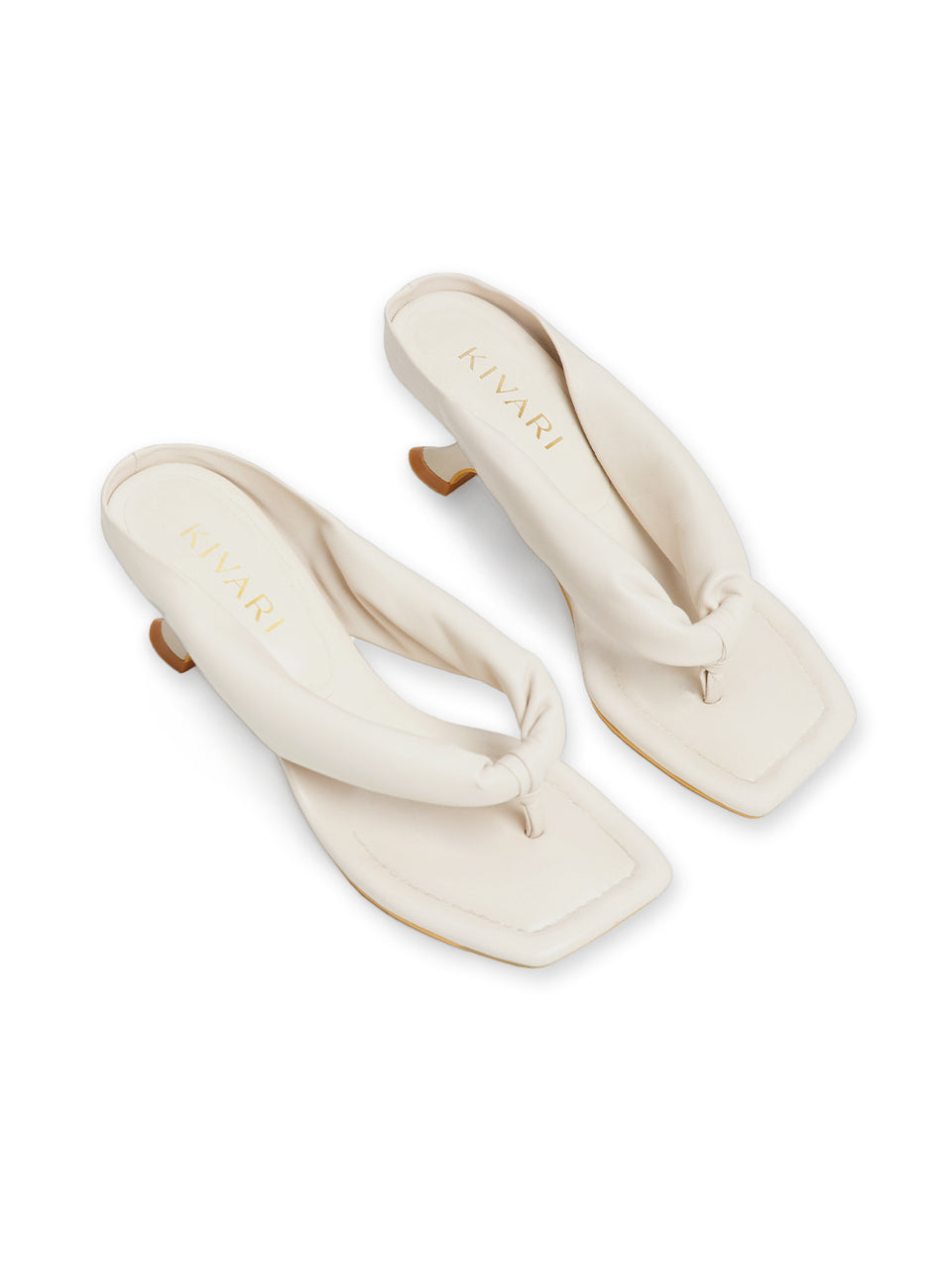 Pair of cream-colored sandals with a knot design on a white background
