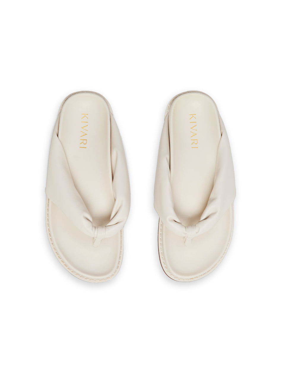Pair of cream-colored slides on a white background