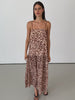 Women wearing leopard print dress in front of white wall